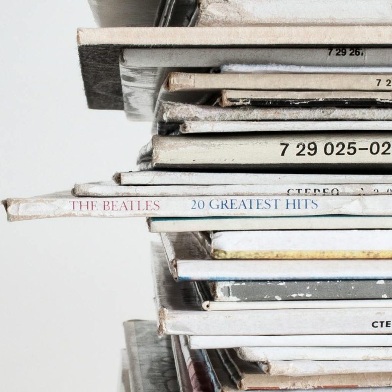 piled vinyl records with white background